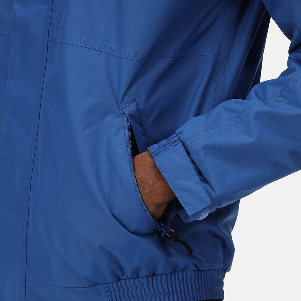 Image of a man with his hands in his pocket wearing a Dover jacket