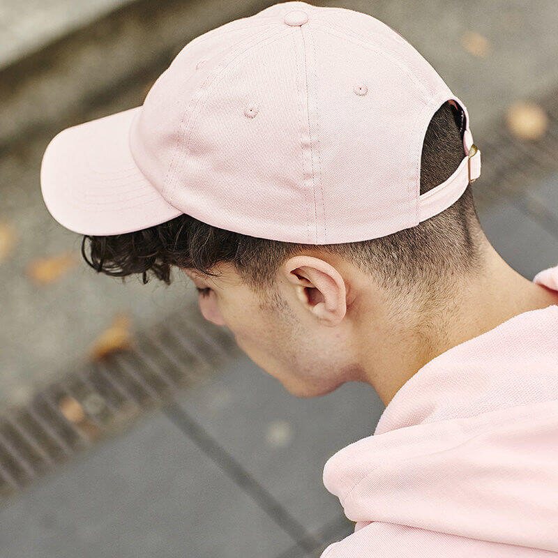 Photo of man wearing a pink cap