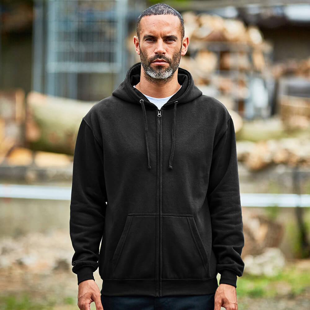 Image of a man wearing a black zipped hoodie